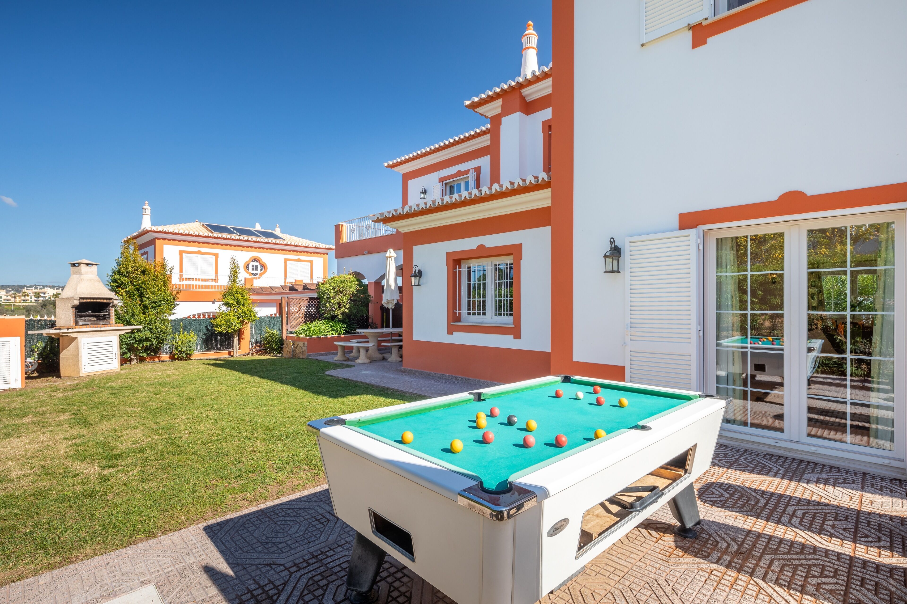 Una mesa de billar en un patio con un edificio al fondo.