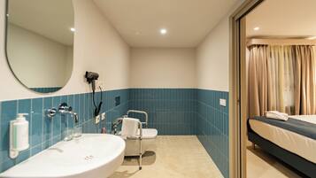 A bathroom with a sink, mirror, and toilet.