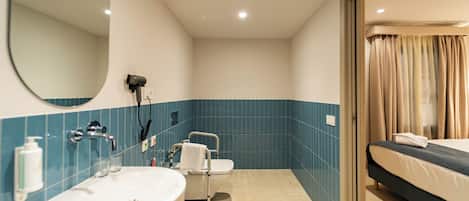 A bathroom with a sink, mirror, and toilet.