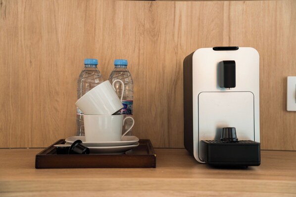 A coffee machine, a white cup, and two water bottles on a tray. - Hotel San Lorenzo Catedral (València)