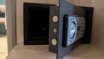 A black-framed object with two visible screws and a circular component on a wooden surface.