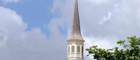 A church with a tall steeple and a clock tower.