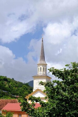 A church with a tall steeple and a clock tower.