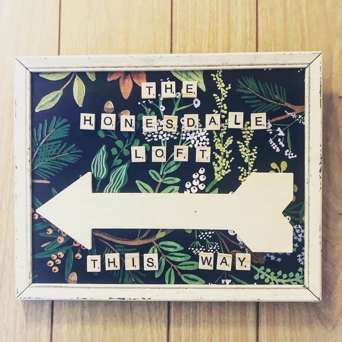 A framed sign with the text "The Honsdale Loft" and an arrow pointing left.