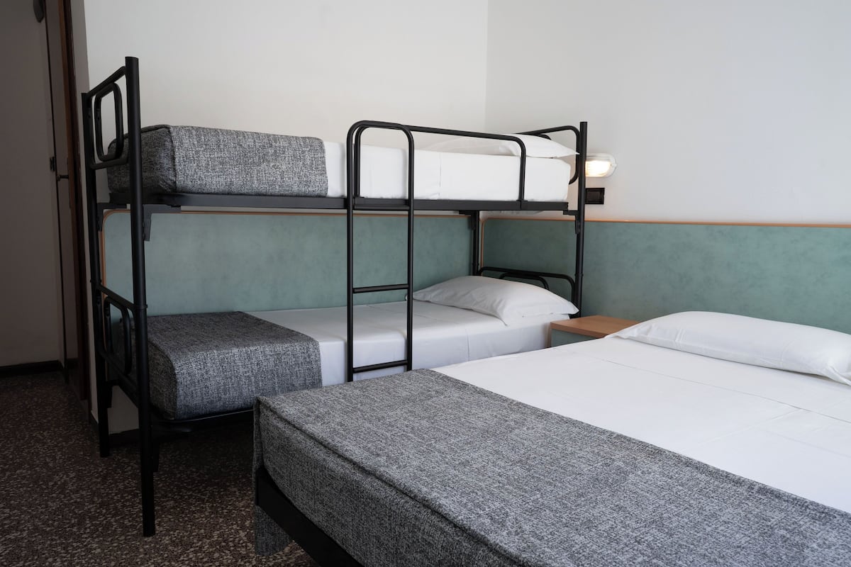 Classic Quadruple Room, Partial Sea View | In-room safe, desk, free WiFi, bed sheets