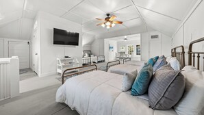 A spacious bedroom with a large bed, a ceiling fan, a TV, and a view of the outside. - The Darcy Victorian Home - Walk to Downtown, Grill, Large Dining (Hot Springs)