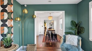 A dining area with a wooden table and chairs, a chandelier, and a view into another room. - Historic Franklin Retreat Game Room Covered Patio Easy Downtown Access The Carolyn House by Avantstay (Franklin)
