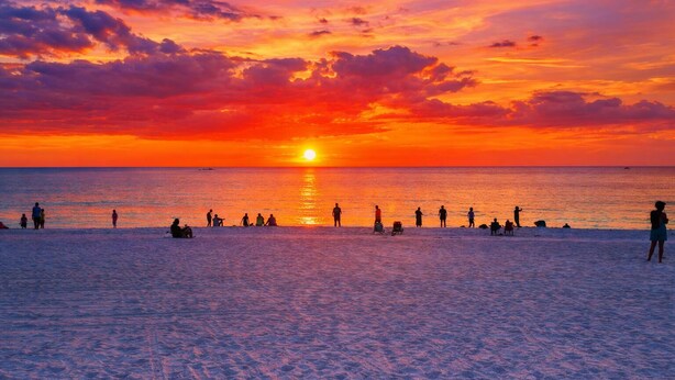 A beach at sunset with people relaxing and sunbathing. - Closest Home to South Beach on Marco Island (Marco Island)