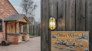 A wooden fence with a sign reading "Otters Rest" and a lamp post. - Otter's Rest (Droitwich)