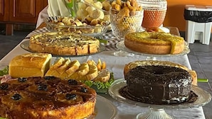 A buffet table with various desserts and pastries. - Pousada Taba de Canes (Canavieiras)