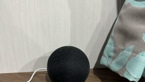 A black speaker on a wooden shelf with a white cable connected to it. - Butlins Skegness - Holiday Accommodation 21028 (Skegness)