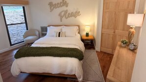 A bedroom with a bed, a bedside table with a lamp, a chair, a window, and a wardrobe. - Beech Please (Beech Mountain)