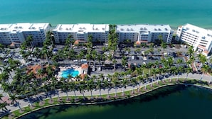 A high-rise hotel with multiple floors, a central swimming pool, and a surrounding parking area. - Bahia Vista 363 (St. Petersburg)