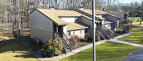 A row of small, single-story buildings with a simple, functional design, likely serving as residential units or small apartments.