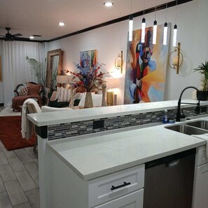 A modern kitchen with a white countertop, a dishwasher, and a sink. - New Gated 2BR Near Medical Center, NRG & Downtown (Houston)