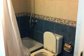 A small bathroom with a toilet, a shower, and a towel rack. - Entire apartment for 3 people. Buenos Aires. Microcentro. Hipolito from Argentina (Buenos Aires)