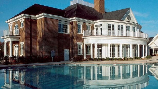 A large, two-story building with a swimming pool in front. - 4th of July Week! - Williamsburg, ONLY => 26 Jun - 3 Jul 2027, Sleeps 12/4Br/4Ba (Williamsburg)