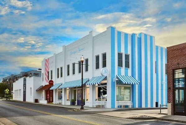 A white building with blue stripes and a sign that reads "Droppers Tins." - 1-BR Condo in 12 South I Unit 202 (Nashville)