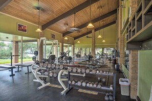 A gym with various exercise equipment, including dumbbells and weight machines, under a wooden ceiling with hanging lights. - All Decked Out 3-bedroom townhome in gorgeous Point Venture with fantastic views (Point Venture)