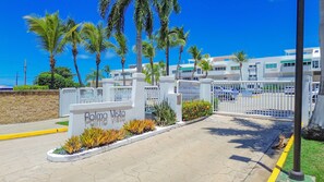A gated entrance to a residential area with a sign reading "Palma Vista."