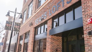 A brick building with the sign "SEARS LOFTS" indicating a retail store. - Sears Lofts | The Voedsch (Aberdeen)