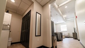 A modern apartment with a kitchen, a dining area, and a living room. - Sears Lofts | The Voedsch (Aberdeen)