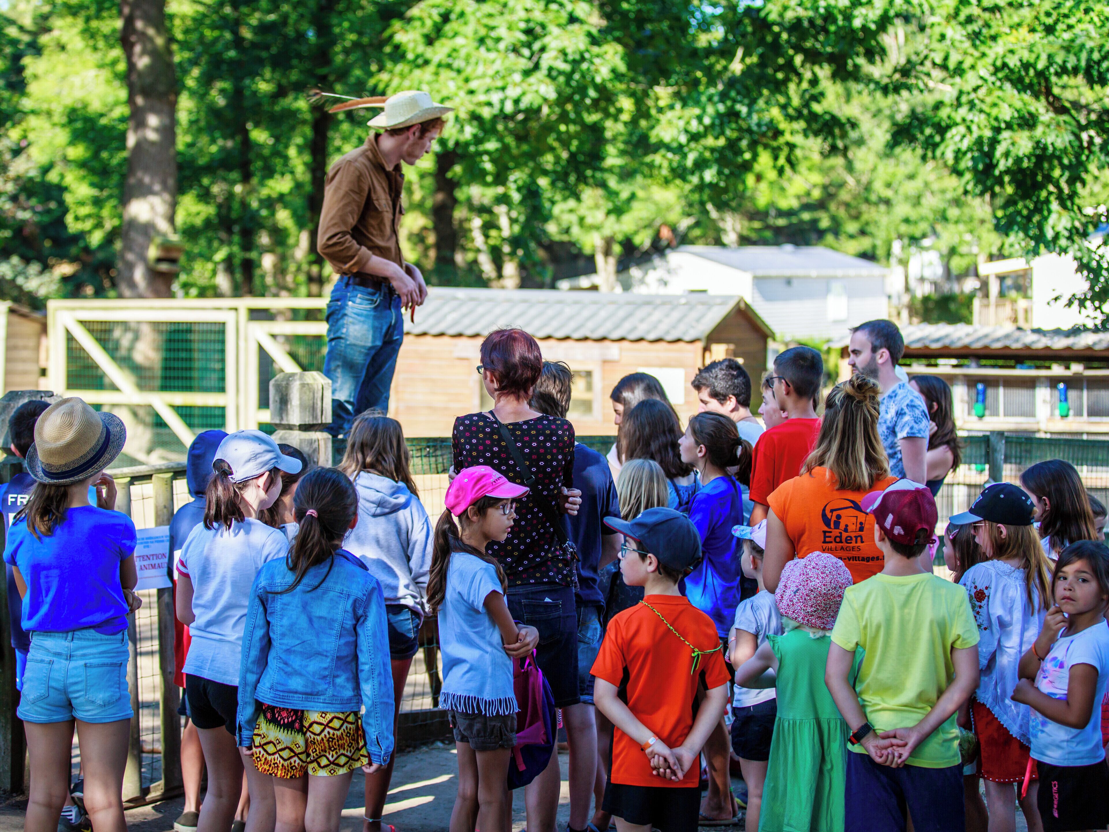 A group of people gathered outdoors, possibly at a public event or park.