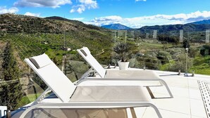 A terrace with lounge chairs overlooking a mountainous landscape. - Finca Moderna w/Private Pool & Views/Tolox (Tolox)