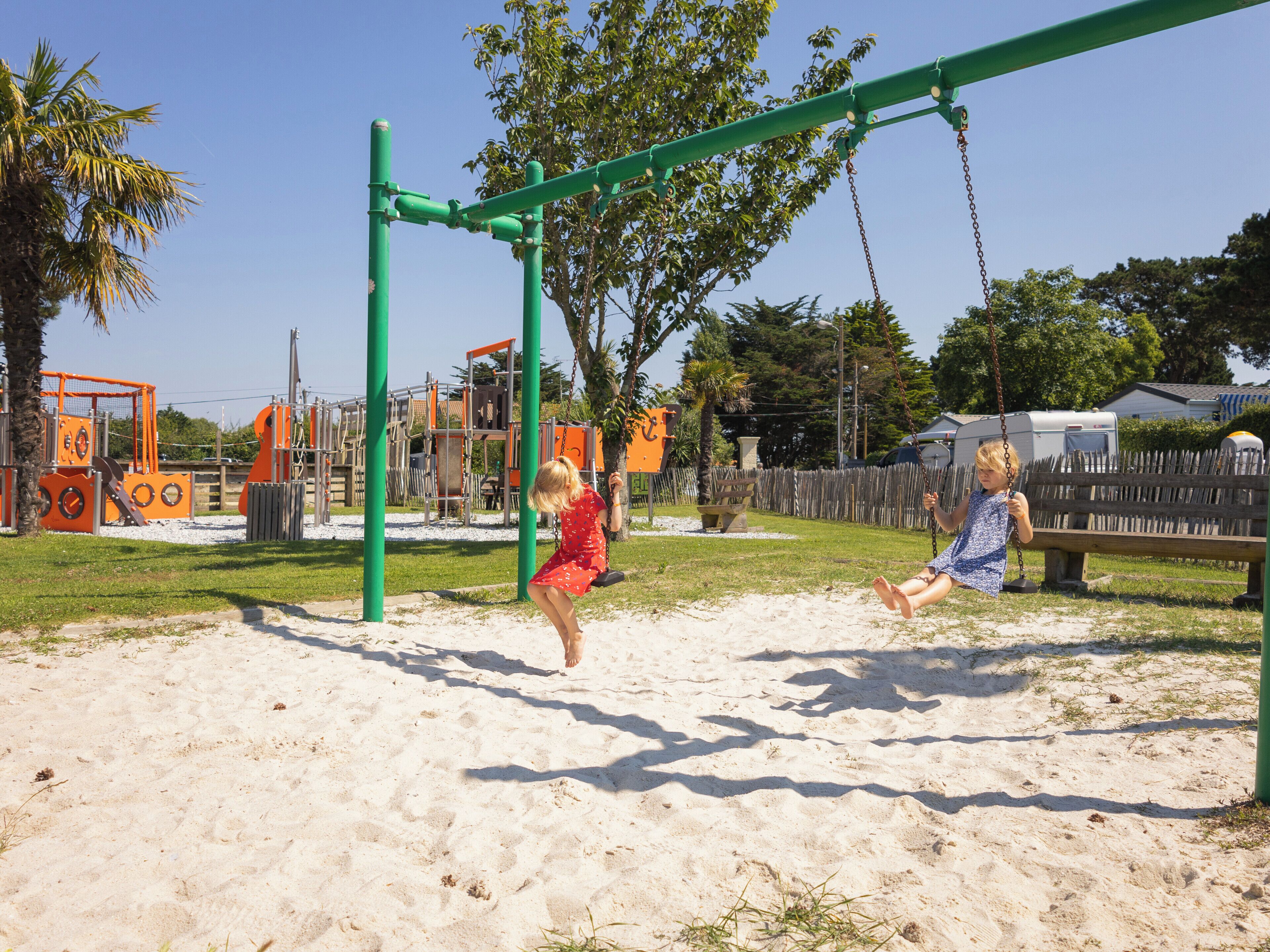 A playground with swings and climbing structures.