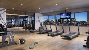 A modern gym with treadmills, exercise bikes, and weight machines. - Haus Mitre Vila Clementino by Wecare (São Paulo)