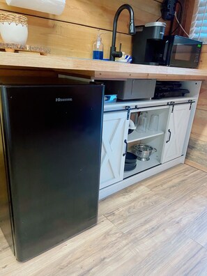 Fridge, microwave, coffee/tea maker, cookware/dishes/utensils