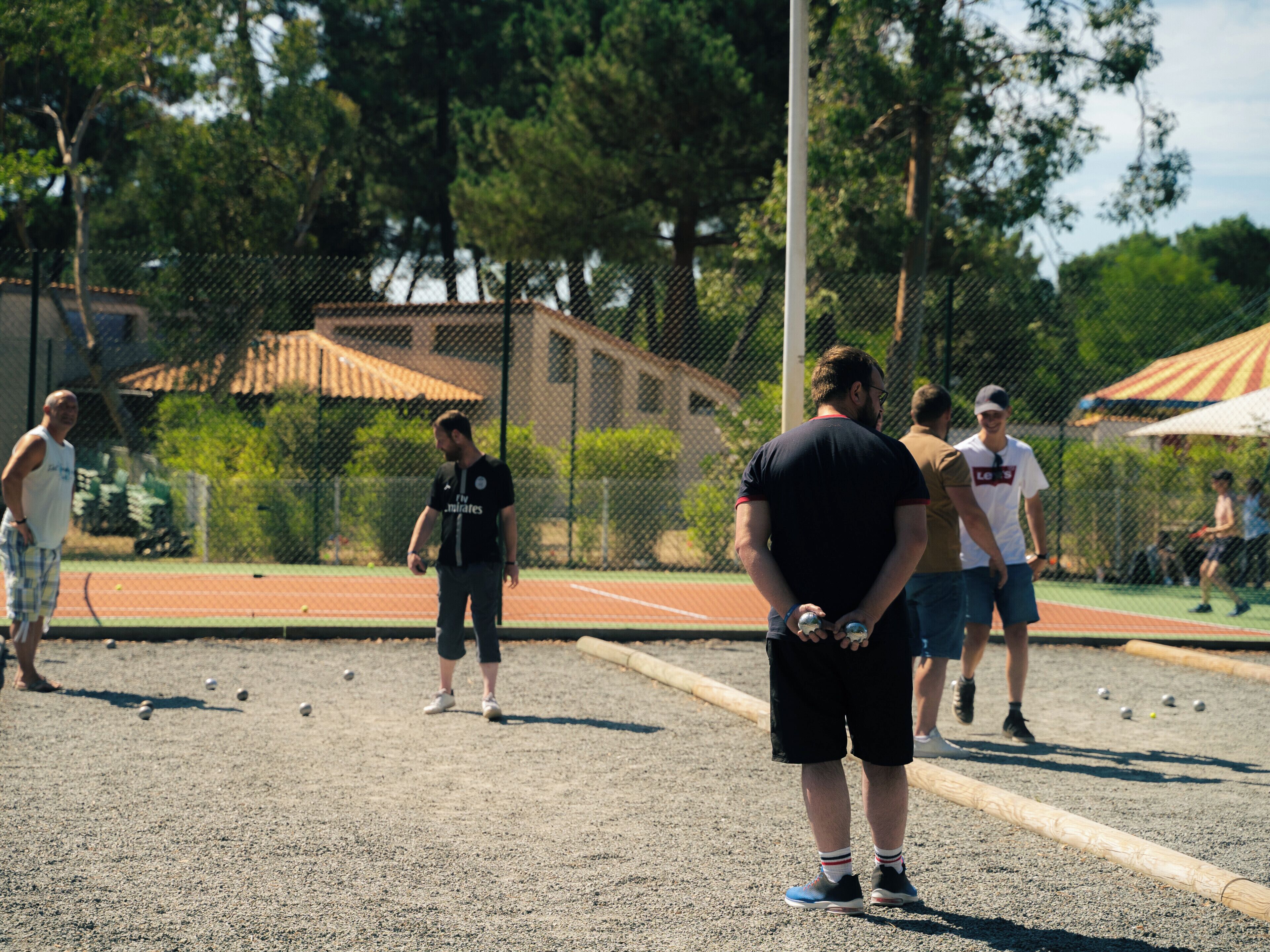 A tennis court with players and a net.