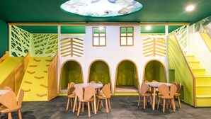 A children's play area with climbing walls, slides, and arched seating. - 1BR Condo w Rooftop Pool Steps from Beach & 5th Ave (Playa del Carmen)