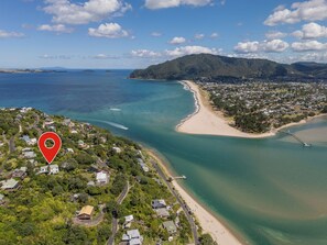 An aerial view of a coastal town with a beach, a bridge, and a forested area. - Panoramic Views on Paku - Tairua Family Retreat (Tairua)