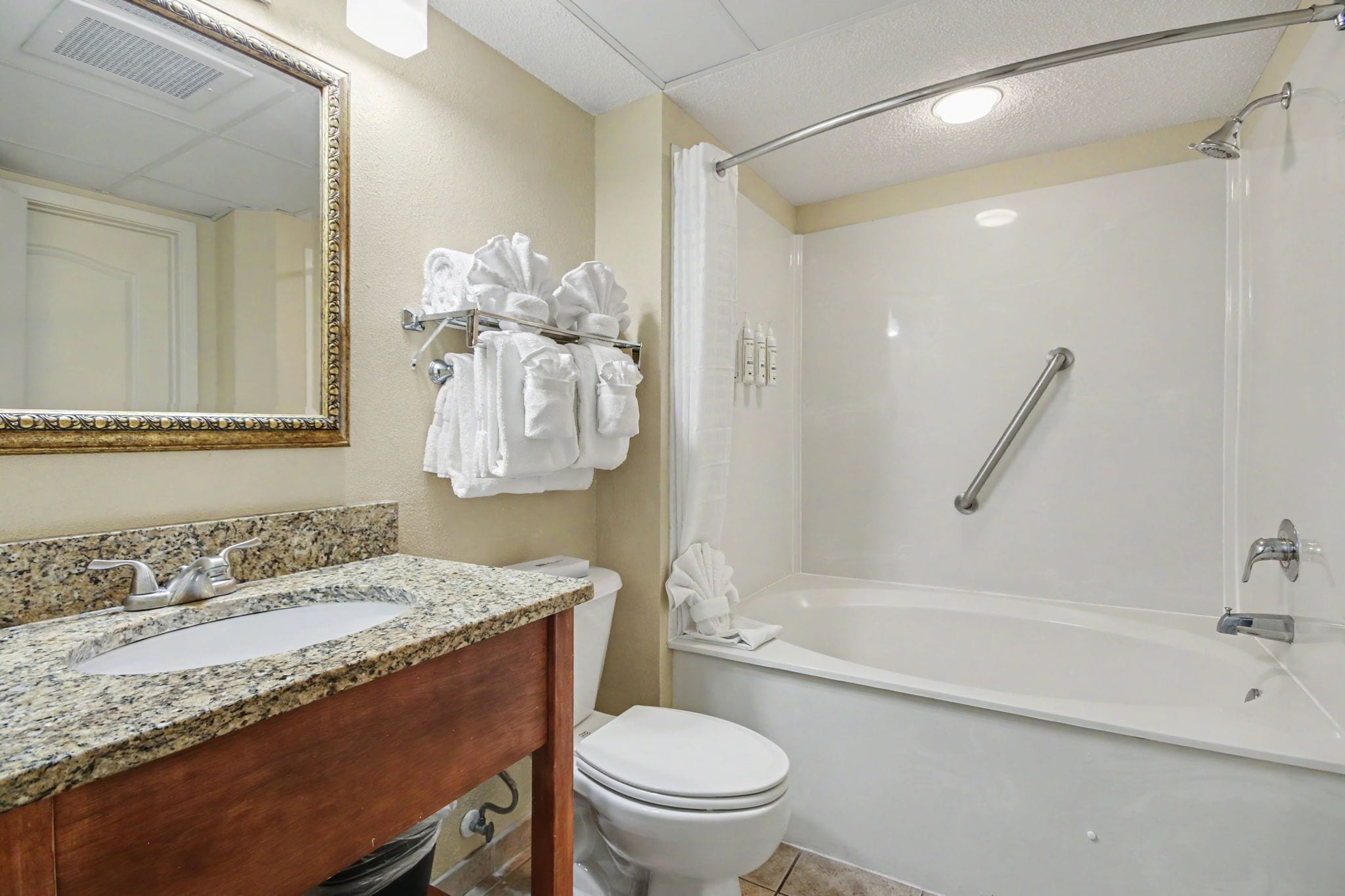 A bathroom with a sink, toilet, and bathtub.