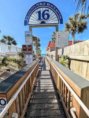 A wooden boardwalk leading to Bay County Public Beach Access, with signs indicating no pets, vehicles, or glass containers allowed, and no alcoholic beverages on the beach. - 60 Steps to Beach, Home with Private Pool and Separate Bungalow (Panama City)