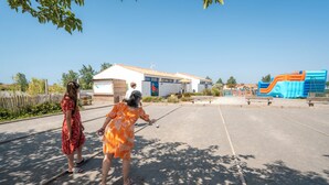 An outdoor area with a building, a playground, and a clear sky. - Carva - Confort 2 TV - 5p (57) (La Guérinière)