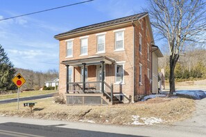 A two-story brick house with a porch and a mailbox. - Clever Rabbit- Raystown Lake-Seven Points- Aunt Susies (Hesston)