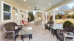 A covered patio with wicker furniture, a glass table, and a ceiling fan. - Clever Rabbit- Raystown Lake-Seven Points- Aunt Susies (Hesston)