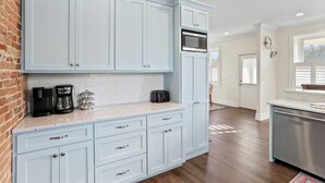 A kitchen with light blue cabinets, a microwave, a coffee maker, and a toaster. - Clever Rabbit- Raystown Lake-Seven Points- Aunt Susies (Hesston)