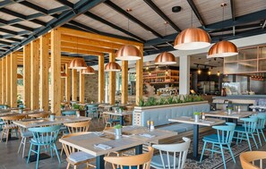 A restaurant with wooden beams, blue chairs, and copper pendant lights. - 2 bedroom stunning (sta)caravan in Vabriga (Vabriga)