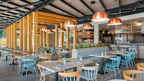 A restaurant with wooden beams, copper pendant lights, and a bar area. - Lovely (sta)caravan in Vabriga (Vabriga)