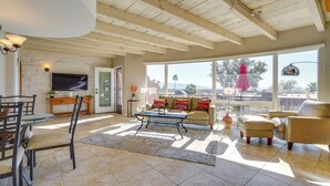 A spacious living room with a high ceiling, large windows, and a cozy seating area. - Catalina Foothills Gem 8 Mi to Sabino Canyon (Tucson)