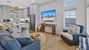 A modern kitchen with grey cabinets, a built-in oven, and a large island. - Palmilla Resort home with heated pool, golf, beach access, balconies, W/D, AC (Port Aransas)