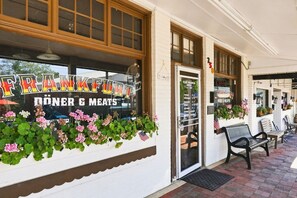 A storefront with a sign reading 'FRANKFURT DÖNER & MEATS' and a list of opening hours.
