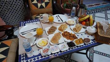 A breakfast table with various dishes, including toast, eggs, and fruit.