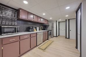 A modern kitchen with stainless steel appliances, a microwave, and a coffee maker.