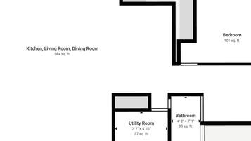 Plano de planta que muestra una cocina, sala de estar, comedor, baño y cuarto de servicio.