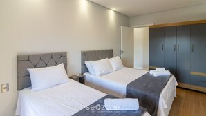 A hotel room with two beds, a wardrobe, and a bedside table. - Apt With Barbecue 200 m From the Beach Ifa0054 (Penha)