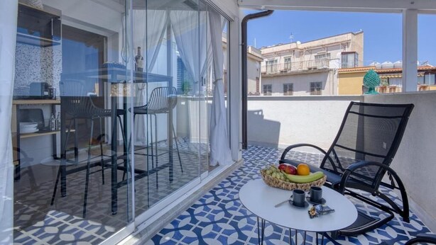 A balcony with a table, chairs, and a fruit basket. - VFH La Rada Apartments (Porticello)